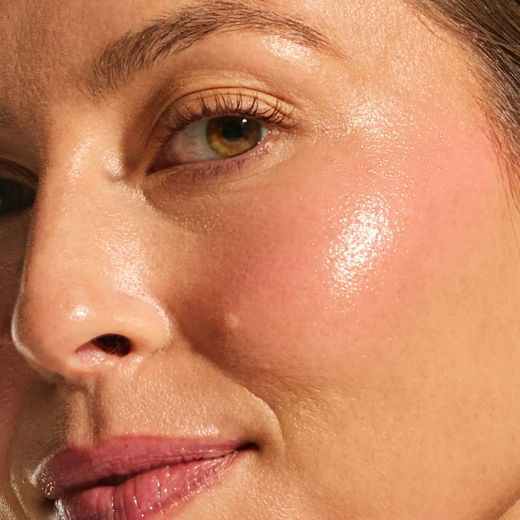 Close-up of light skin tone showing plump, bouncy cheek texture with a sheer pink flush from the Annadea Power Walk Blush Serum in Soft Step, reflecting the hyaluronic acid formula's hydrating and smoothing results