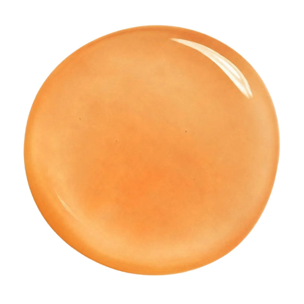 Close-up swatch of Annadea To Dew Glow Serum showing its translucent amber gel texture, a velvety hydrating serum that melts into skin to brighten and deeply moisturise