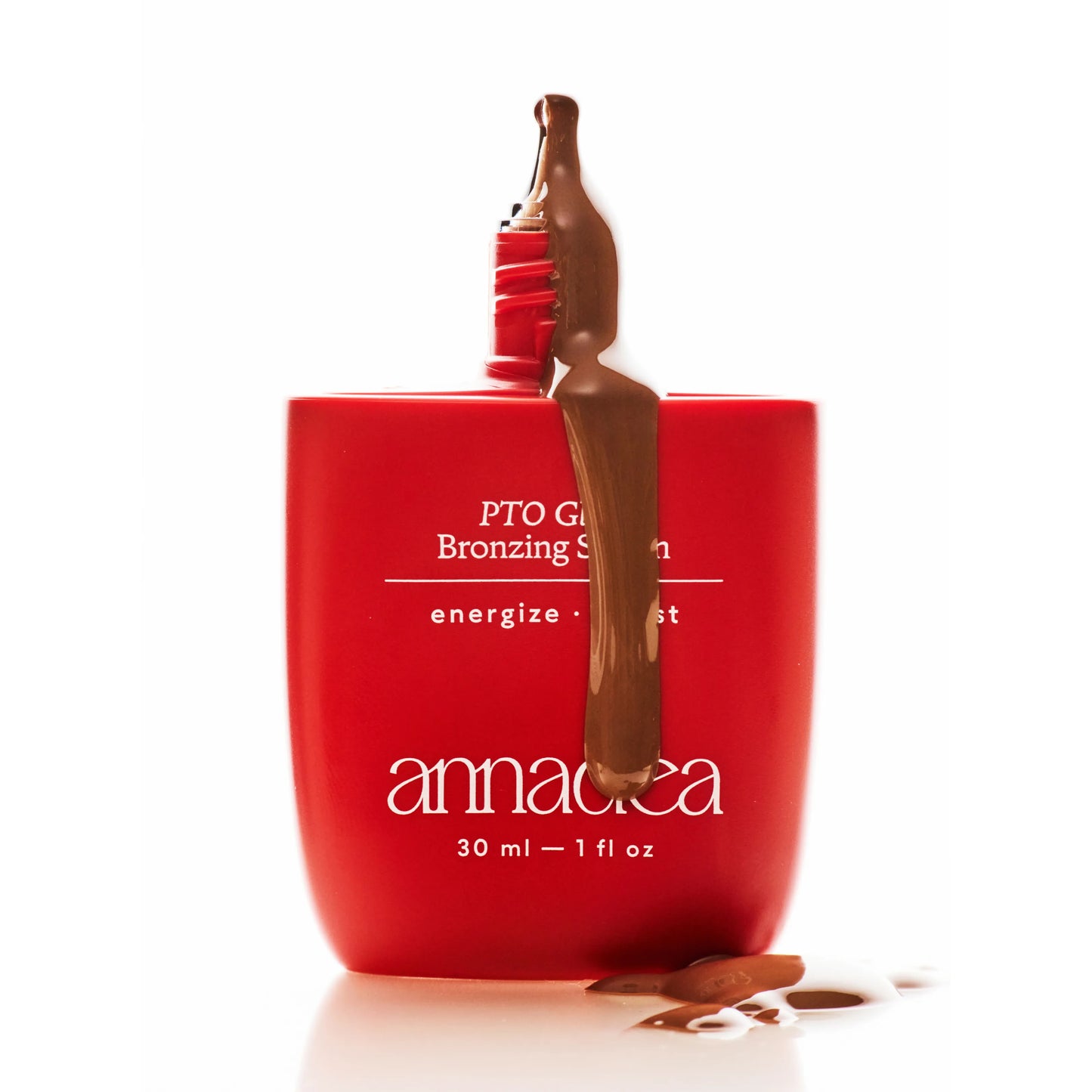 Annadea PTO Glow Bronzing Serum matte red bottle with rich bronze serum dripping from the applicator, showing the silky serum texture and warm buildable pigment of the bronzing formula