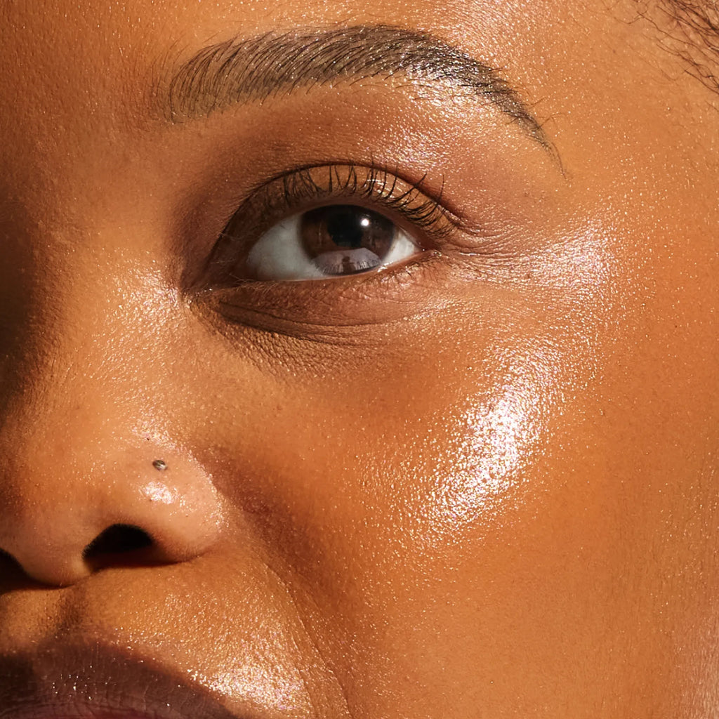 Close-up of deep skin tone showing a naturally toasted, luminous glow from the Annadea PTO Glow Bronzing Serum, showcasing the serum's buildable bronze pigment and warm sun-kissed radiance