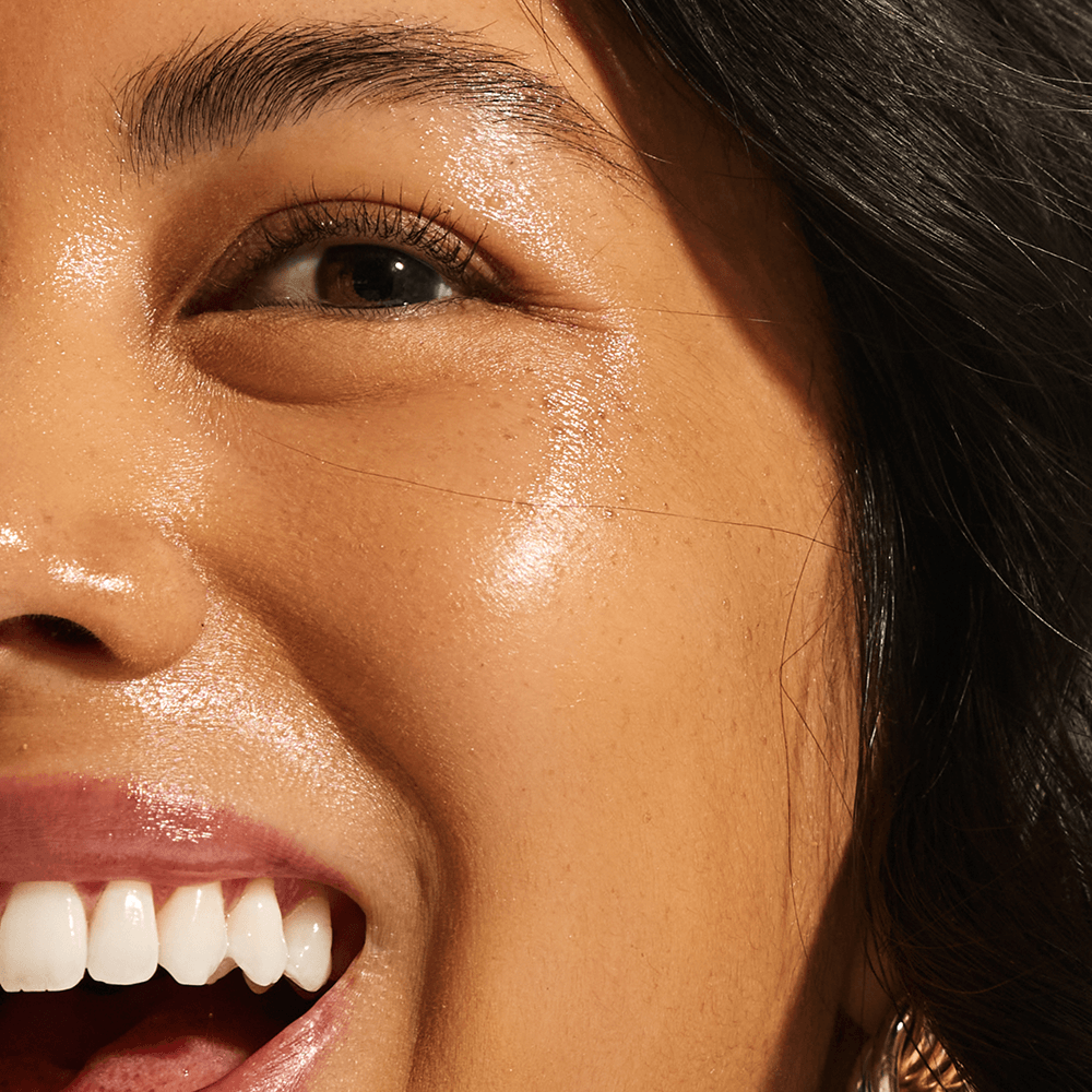 lose-up of glowing medium skin tone showing visibly brightened and even complexion from Annadea To Dew Glow Serum niacinamide and licorice root extract
